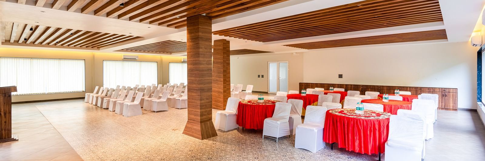 Banquet Hall at DLS Divine River Resort and Spa featuring  chairs table and a stage
